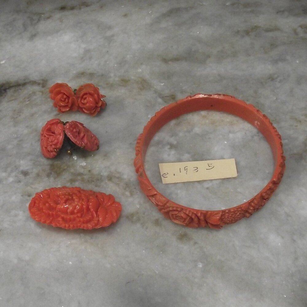 Vintage maybe Bakelite carved jewelry set coral color